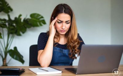 Business woman frowns at computer screen